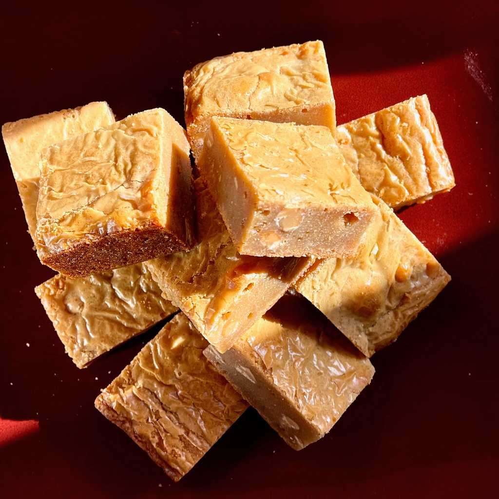This bake sits exactly halfway between Peanut Butter Fudge, and Blondies. The bars are dense, nutty, barely crumbly, and rich like fudge. But they're also a little chewy, with the papery crust you'd expect from any half-decent brownie or blondie. If you like peanut butter, these are for you.